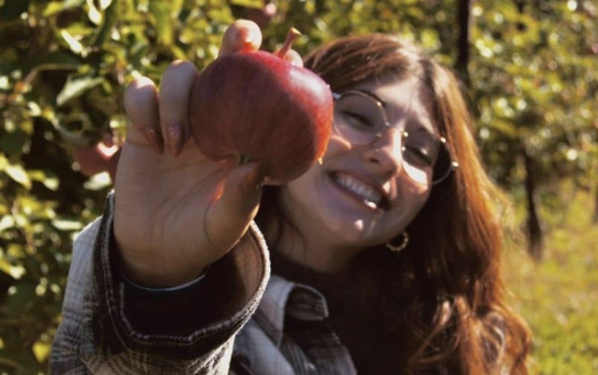 Girl showing a freshly picked apple